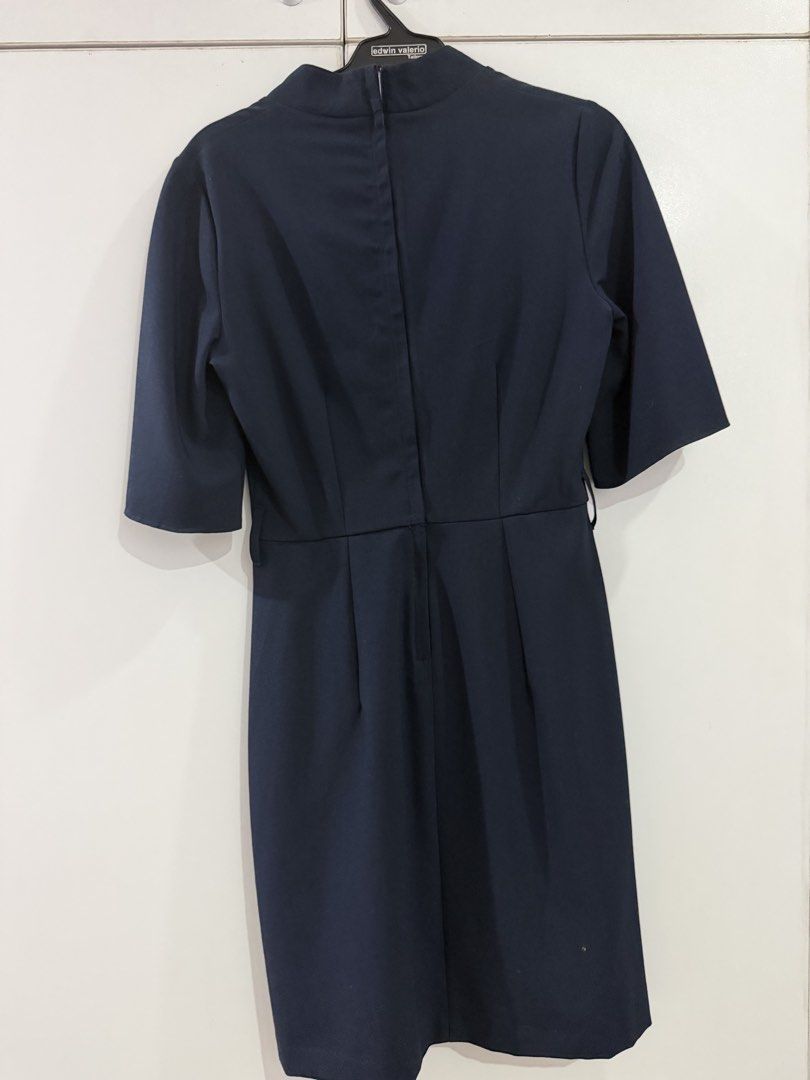 Navy Blue V-Neck Flutter Sleeve Dress (Category: Dresses) located in Manila. Submitted by nicolebrave (Listing ID 1460416746, Image 3). Description: - Navy blue V-neck dress - Flutter sleeves - Knee-length - Fitted waist - Back zip closure - Versatile for work or casual outings - Simple and classic design.