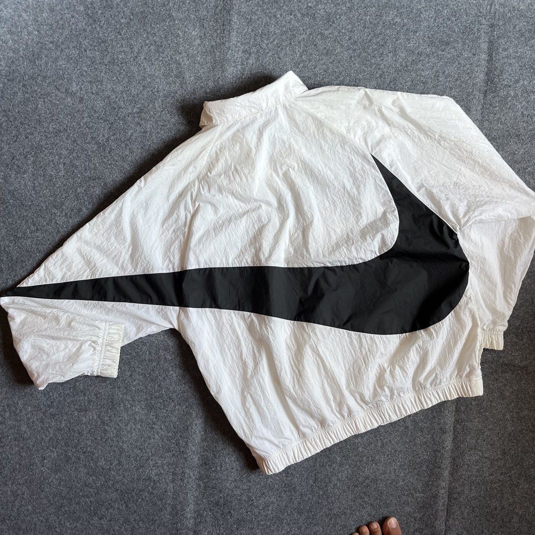 Nike Big Swoosh White Windbreaker Jacket (Category: Coats, Jackets and Outerwear) located in Cebu City. Submitted by booksii3232 (Listing ID 1460350553, Image 2). Description: - White Nike windbreaker jacket - Large black swoosh design - Quarter zip closure - Inner mesh lining for breathability - Made in Vietnam - Size: Large.
