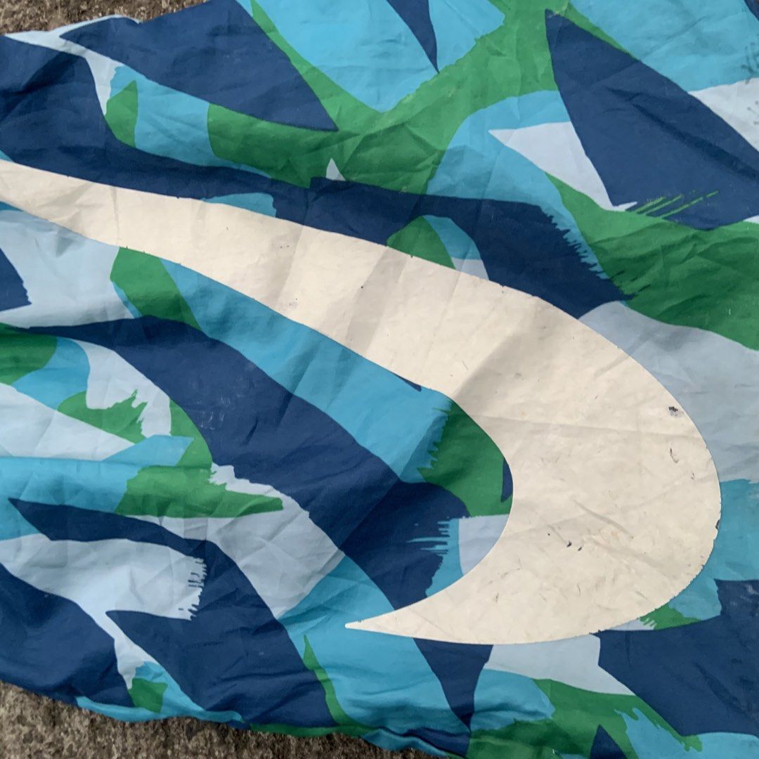 Nike Drawstring Bag - Blue Green Abstract Print (Category: Sling Bags) located in Tabaco. Submitted by bayhust (Listing ID 1460451124, Image 2). Description: - Cool Nike drawstring bag - Vibrant blue and green abstract pattern - Iconic white Nike swoosh - Ideal for gym, sports, or everyday use - Easy to carry with shoulder straps minimal scratch and need wash.