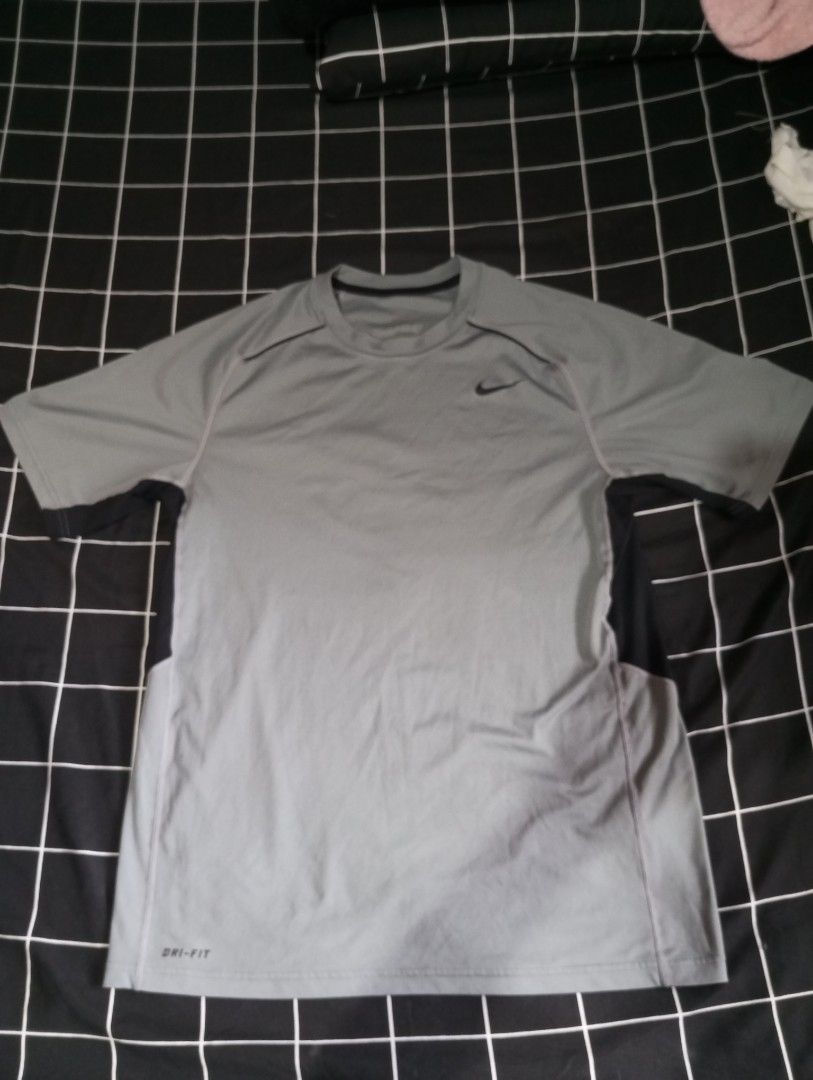 Nike Dri-FIT Grey T-shirt (Category: Tshirts & Polo Shirts ) located in Imus. Submitted by wreckitralph_ (Listing ID 1460361830, Image 1). Description: - Grey Nike Dri-FIT t-shirt - Short sleeves with black side panels - Ideal for workouts or casual wear - Comfortable and breathable fabric.
