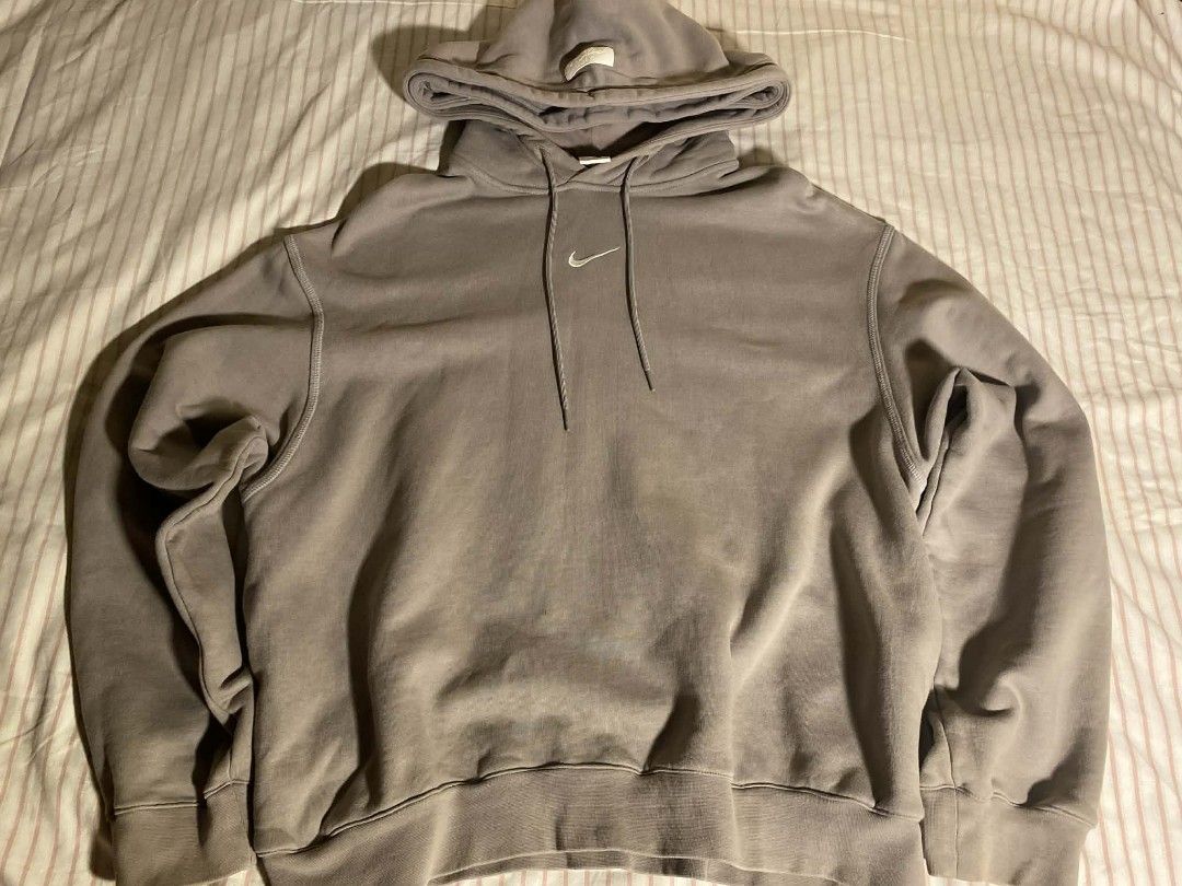 Nike Grey Pullover Hoodie (Category: Coats, Jackets and Outerwear) located in Manila. Submitted by vin.m (Listing ID 1460403645, Image 1). Description: - Nike x FOG hoodie - Features embroidered Nike swoosh logo on chest - Comfortable pullover design with adjustable hood and drawstrings - Ribbed cuffs and hem for a snug fit - Ideal for everyday casual wear.
