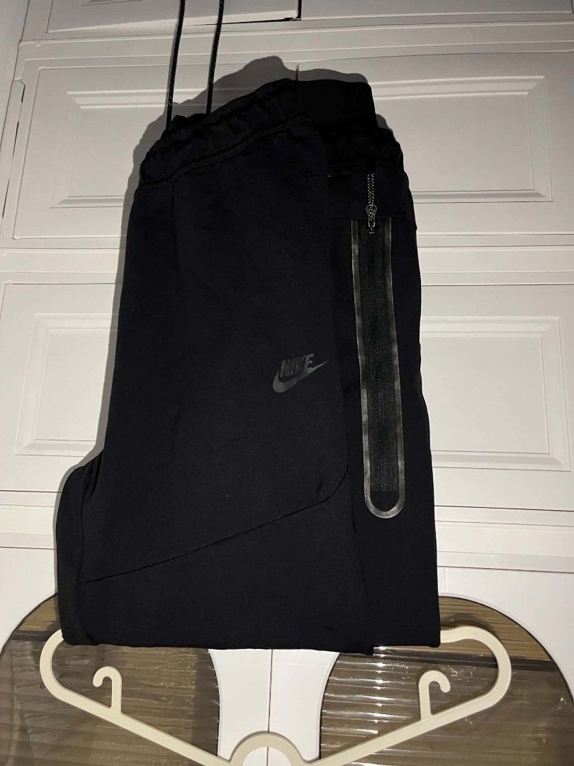 Nike original (Category: Joggers) located in Manila. Submitted by cleverearth.125e3f (Listing ID 1460500811, Image 2). Description: - Two pairs of black Nike pants available. - One pair features stylish white stripe details. - The second pair is the popular Nike Tech Fleece. - Both pairs proudly display the iconic Nike logo. - Ideal for everyday casual wear or athletic activities..