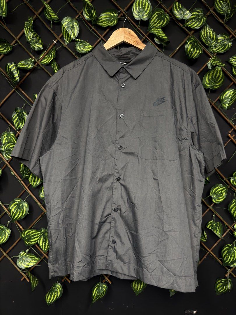 Nike Short Sleeve Button Up Shirt (Category: Tshirts & Polo Shirts ) located in Manila. Submitted by raven236 (Listing ID 1460462467, Image 1). Description: - Grey Nike short sleeve button up shirt - Features a small embroidered Nike logo on the chest - Classic collar and button front - Relaxed fit - Ideal for casual wear or layering.