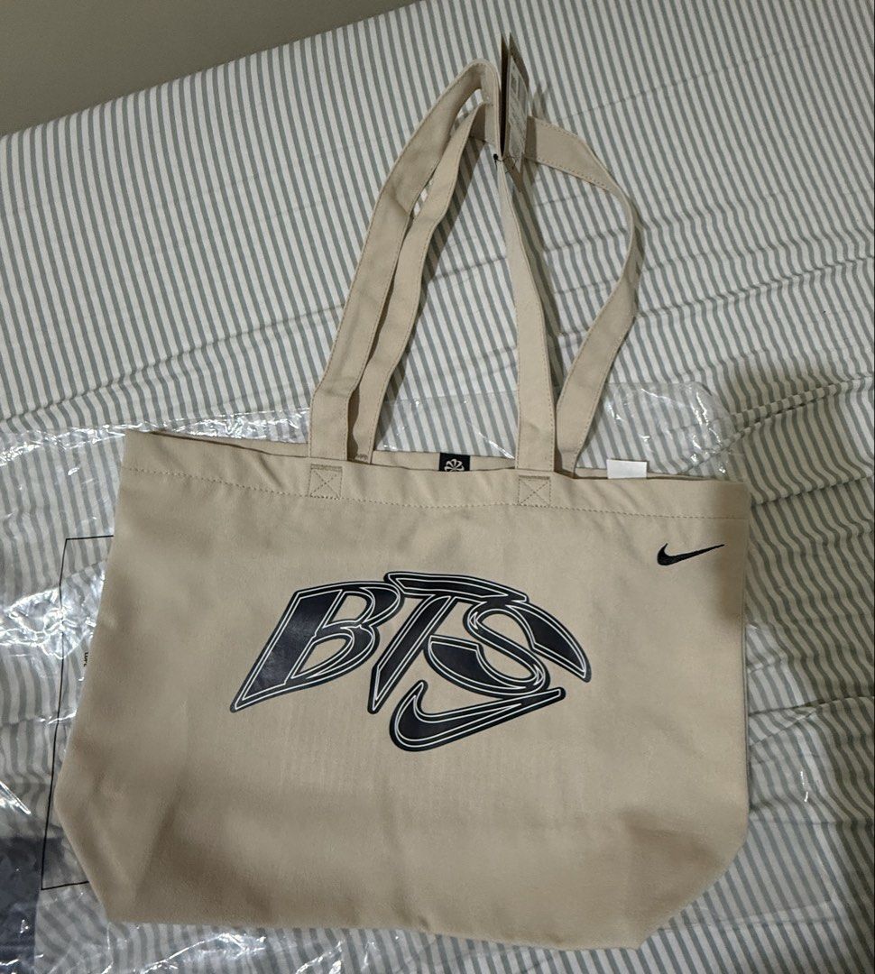 Nike x BTS Collaboration Tote Bag (Category: Tote Bags) located in Makati City. Submitted by beshbuy (Listing ID 1460443639, Image 1). Description: Authentic Nike x BTS canvas tote bag in beige. Features BTS logo and Nike Swoosh. "Nike Just Do It" inside. Size 22L. Made in Vietnam. Bought in BGC.
