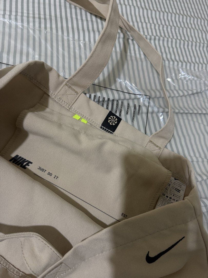 Nike x BTS Collaboration Tote Bag (Category: Tote Bags) located in Makati City. Submitted by beshbuy (Listing ID 1460443639, Image 3). Description: Authentic Nike x BTS canvas tote bag in beige. Features BTS logo and Nike Swoosh. "Nike Just Do It" inside. Size 22L. Made in Vietnam. Bought in BGC.