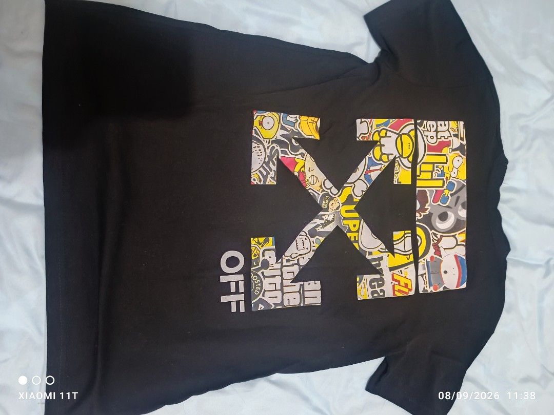 Off-White "Main Label" Graphic T-Shirt Size S (Category: Tshirts & Polo Shirts ) located in Dasmarinas. Submitted by didithtorres7787 (Listing ID 1460331635, Image 2). Description: - Brand: Off-White - Color: Black - Size: S - Features: Iconic chest logo - Back Design: Large graphic print with cartoon characters and "OFF" text - Material: 100% Cotton - Origin: Designed in Italy.