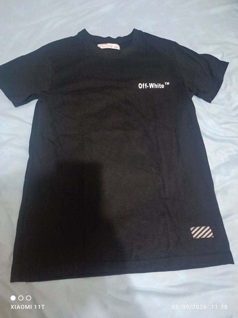 Off-White "Main Label" Graphic T-Shirt Size S (Category: Tshirts & Polo Shirts ) located in Dasmarinas. Submitted by didithtorres7787 (Listing ID 1460331635, Image 1). Description: - Brand: Off-White - Color: Black - Size: S - Features: Iconic chest logo - Back Design: Large graphic print with cartoon characters and "OFF" text - Material: 100% Cotton - Origin: Designed in Italy.