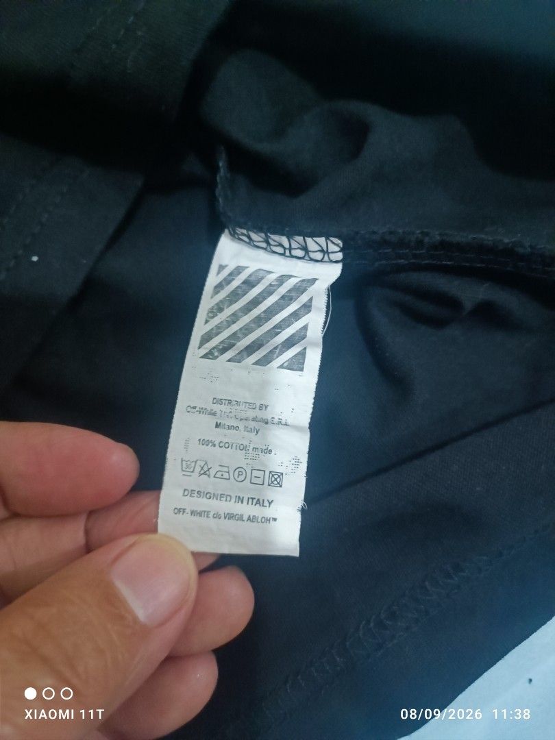 Off-White "Main Label" Graphic T-Shirt Size S (Category: Tshirts & Polo Shirts ) located in Dasmarinas. Submitted by didithtorres7787 (Listing ID 1460331635, Image 3). Description: - Brand: Off-White - Color: Black - Size: S - Features: Iconic chest logo - Back Design: Large graphic print with cartoon characters and "OFF" text - Material: 100% Cotton - Origin: Designed in Italy.