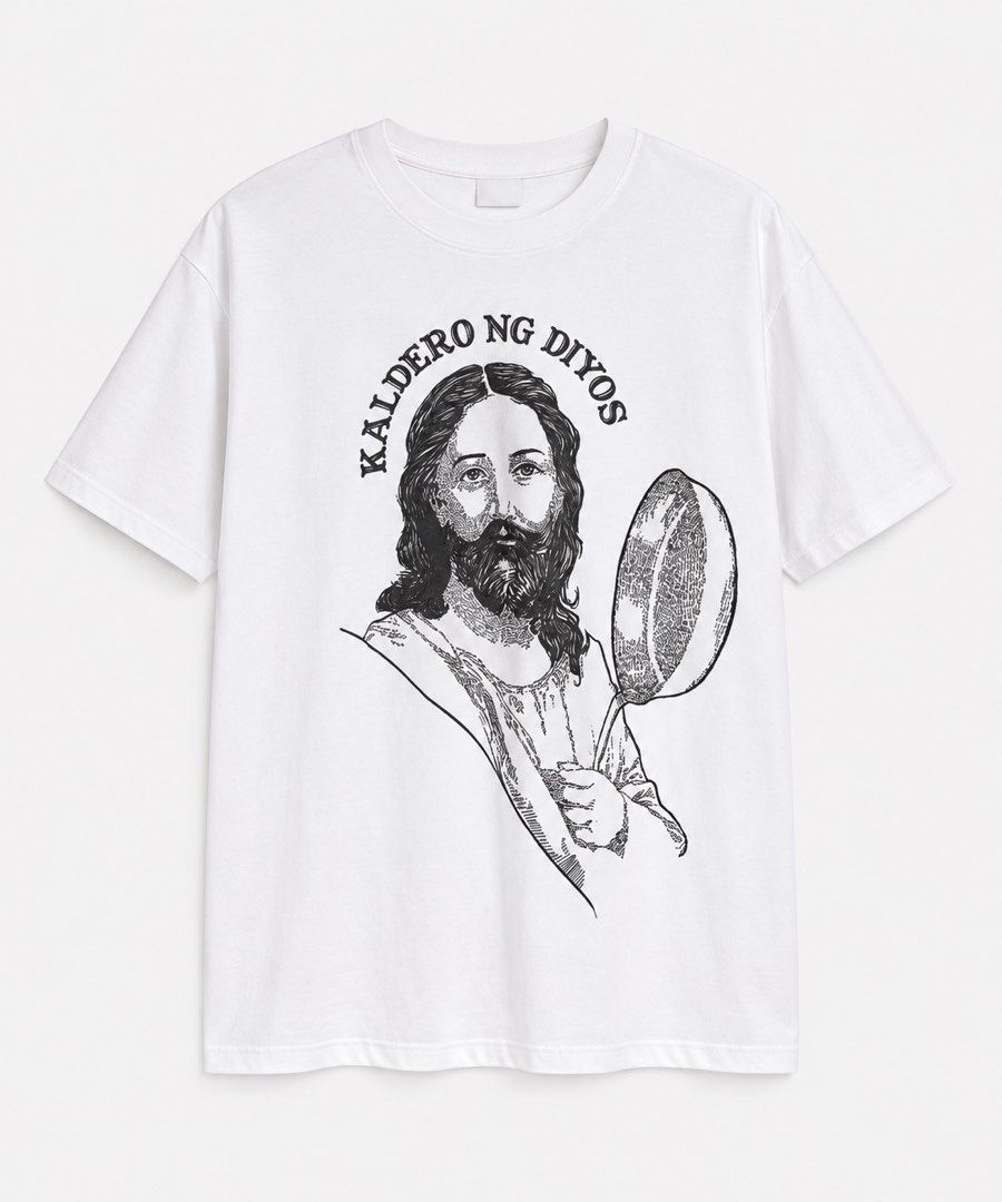 Kaldero ng Diyos Graphic Tee - Medium (Category: Tshirts & Polo Shirts ) located in Manila. Submitted by miafagg0th (Listing ID 1412193028, Image 1). Description: - White FETLAVR t-shirt - Size: Medium - Design: Jesus holding a ladle with "Kaldero ng Diyos" text - Back: Plain white - Condition: Unworn.