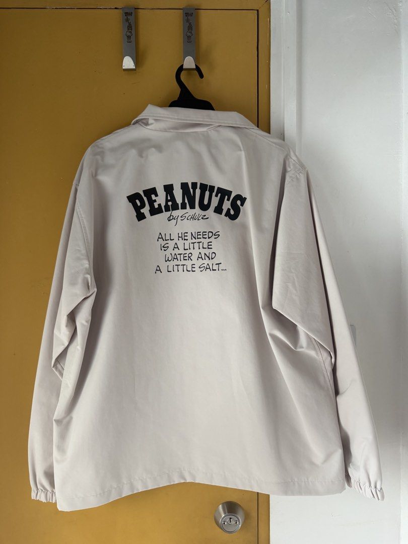 Peanuts Woodstock Coach Jacket (Category: Coats, Jackets and Outerwear) located in San Fernando. Submitted by zeririor (Listing ID 1460350078, Image 2). Description: Peanuts jacket with Woodstock graphic on the front Back has 'Peanuts by Schulz' and a quote Light beige/cream color Button up front NEVER BEEN USED Size L.