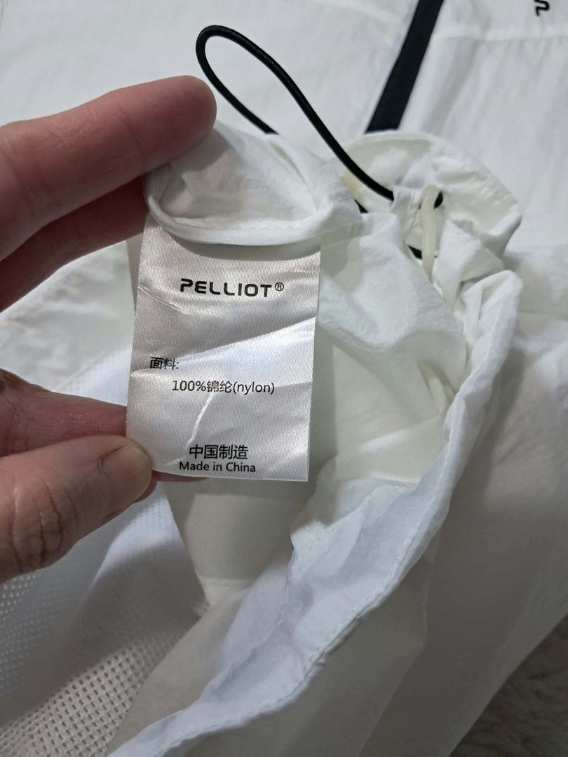 PELLIOT White Pocketable Hooded Jacket Large (Category: Activewear) located in Baguio. Submitted by padisellsz (Listing ID 1460413824, Image 2). Description: - White PELLIOT hooded jacket - Very good condition - Size: Large (fits 22x27.5 inches) - Material: 100% Nylon - Features: Pocketable design, lightweight, breathable with mesh panels, drawstring hood and hem, zipper closure - Ideal for: Travel, sports - Origin: Made in China - May washable s