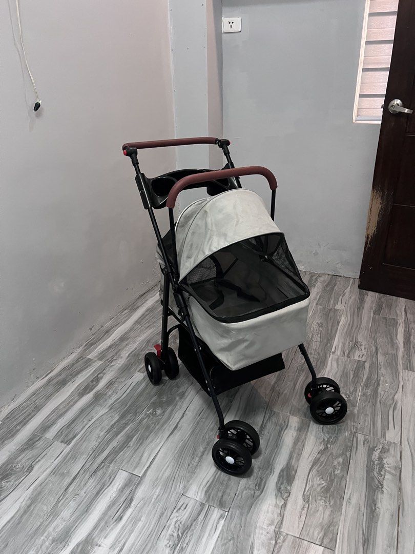 Pet Stroller for Dogs and Cats (Category: Homes & Other Pet Accessories) located in Malolos. Submitted by urgoodsfrommls (Listing ID 1457591138, Image 3). Description: - Used pet stroller, perfect for small to medium-sized pets. - Features a convenient folding mechanism for easy storage. - Includes a spacious storage basket at the bottom for your essentials. - All wheels are in good working condition. - Despite minor cosmetic wear, the stroller r