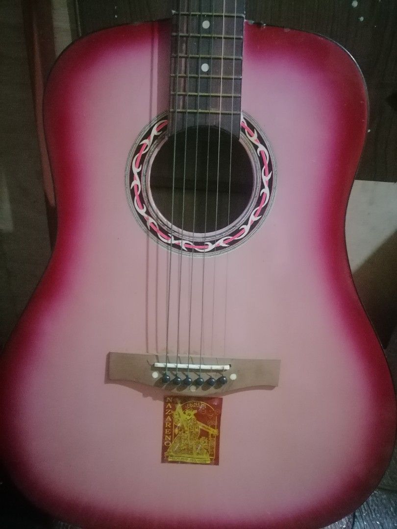 Pink Acoustic Guitar with DJ Initials (Category: Musical Instruments) located in Makati City. Submitted by ryukipama (Listing ID 1460427797, Image 1). Description: - Eye-catching pink acoustic guitar - Minor scuffs present on the neck joint area - Features silver-colored tuners - Ideal for beginner guitarists - Also a fun statement piece for any collection medyu may crack lng po Yung dulo n guitar pero maasyus pa naman po - Ready for its new owne