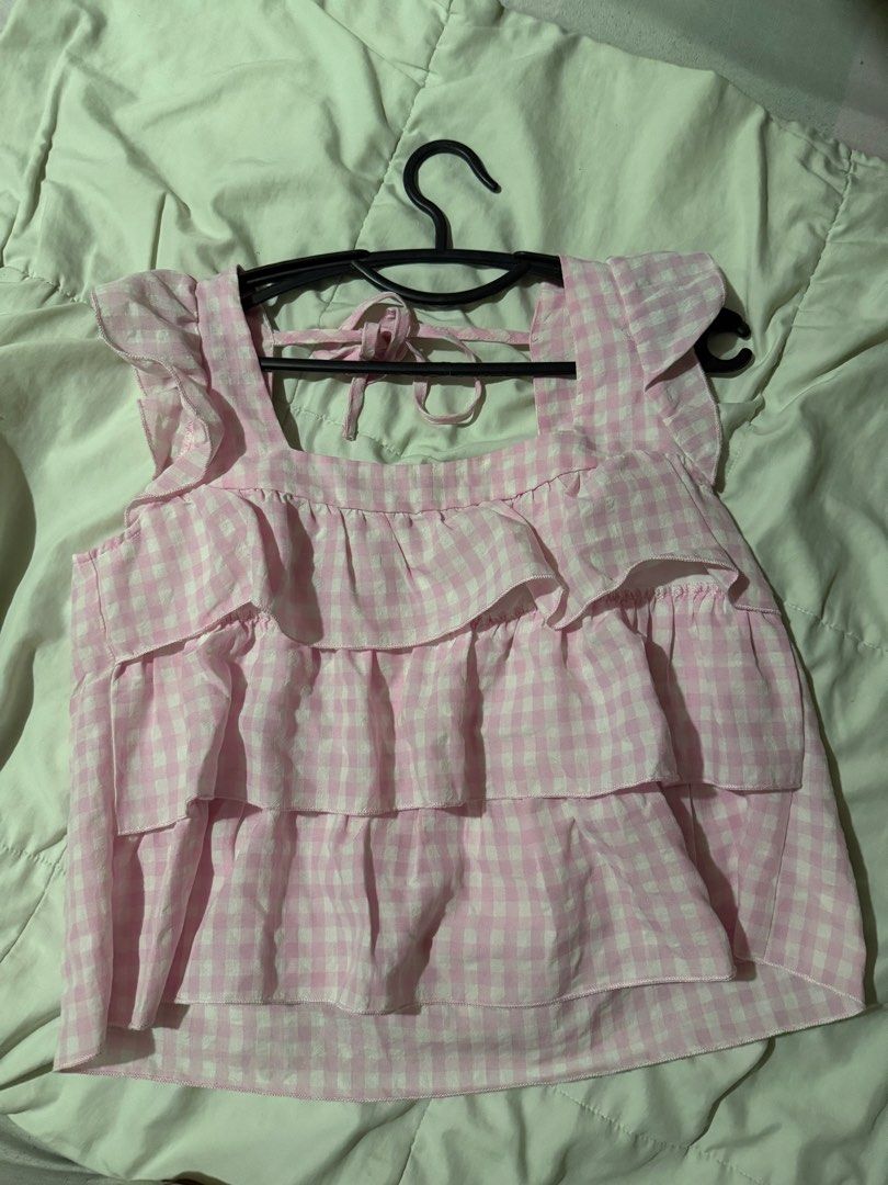 Pink Gingham Tiered Ruffle Square Neck Top (Category: Sleeveless) located in Mabalacat. Submitted by ilovegyu (Listing ID 1460308271, Image 1). Description: - Adorable pink gingham pattern - Flattering square neckline with ruffle trim - Trendy tiered design with ruffles - Adjustable tie-back closure - Sweet flutter sleeves - Ideal for casual wear, picnics, and sunny days.