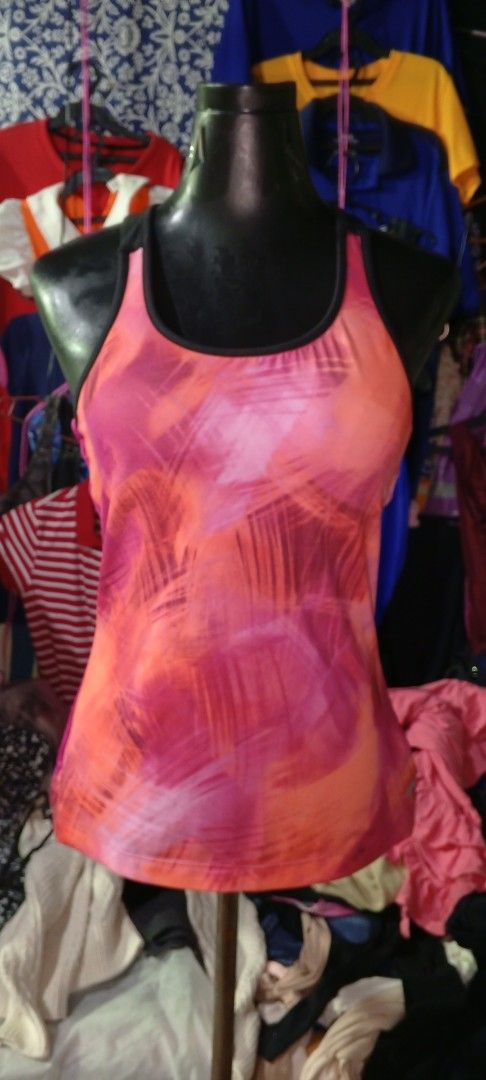 Pink Orange Abstract Print Racerback Tank Top (Category: Sleeveless) located in Manila. Submitted by ezekislacl02490 (Listing ID 1460422773, Image 1). Description: - Vibrant pink and orange abstract print - Racerback style for comfort and mobility - Lightweight and breathable fabric - Solid pink ribbed back panel for added support - Ideal for workouts, gym sessions, or casual outings - Easily pairs with leggings, shorts, or athletic bottoms.
