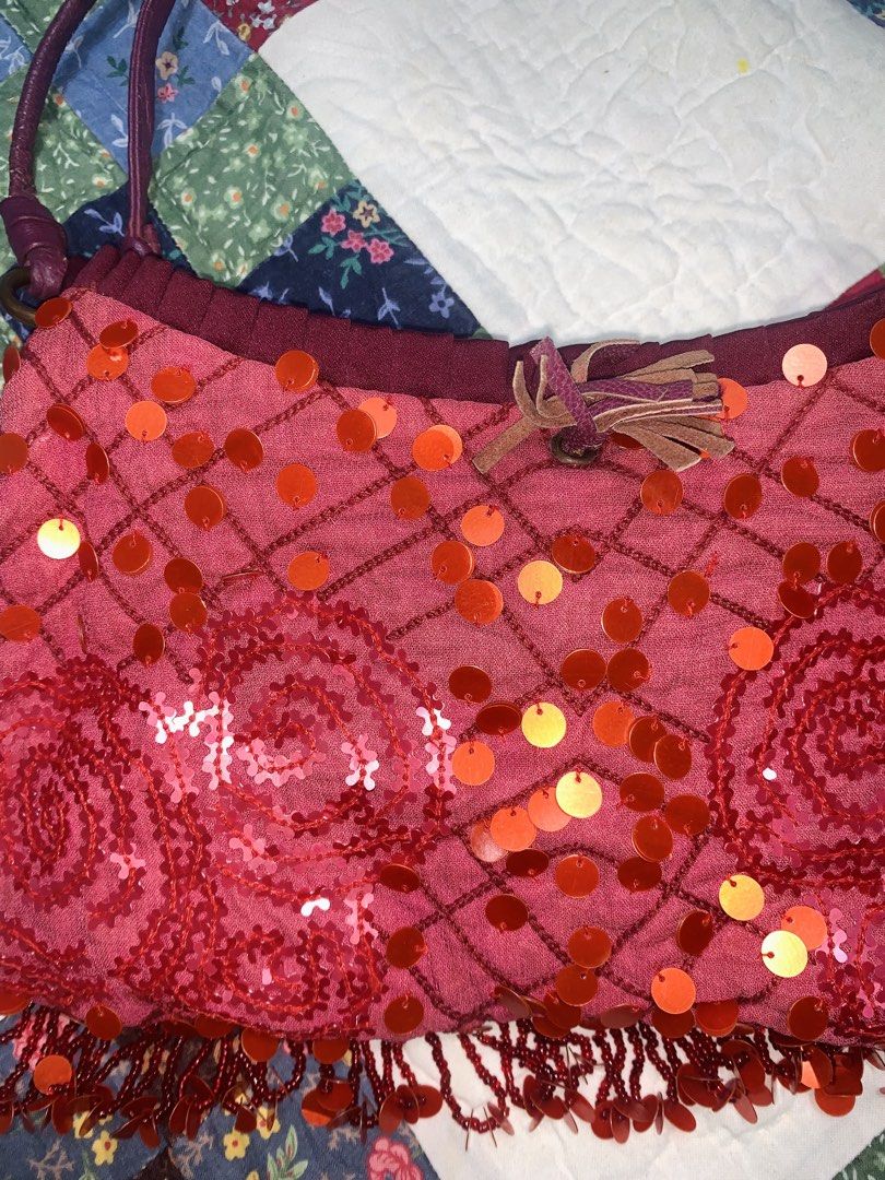Pink Sequin Shoulder Bag with Beaded Fringe (Category: Shoulder Bags) located in Dagupan City. Submitted by sj_styles0910. (Listing ID 1460470012, Image 2). Description: - Cute pink shoulder bag - Covered in sparkly orange and red sequins - Beaded fringe along the bottom - Dark purple straps - Small leather tassel detail - Great for a night out or adding flair to your outfit.