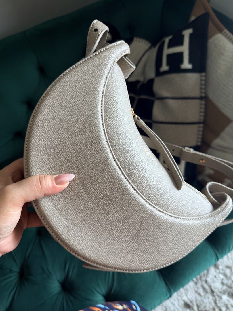 POLENE Crescent Moon Bag Taupe (Category: Luxury Bags & Wallets) located in Makati City. Submitted by adendaya924 (Listing ID 1460400434, Image 2). Description: - Polene crescent moon bag - Color: Taupe - Material: Textured leather - Closure: Gold zipper - Interior: Lined - Strap: Adjustable - Design: Unique moon shape - Versatile: Great for everyday or night out.