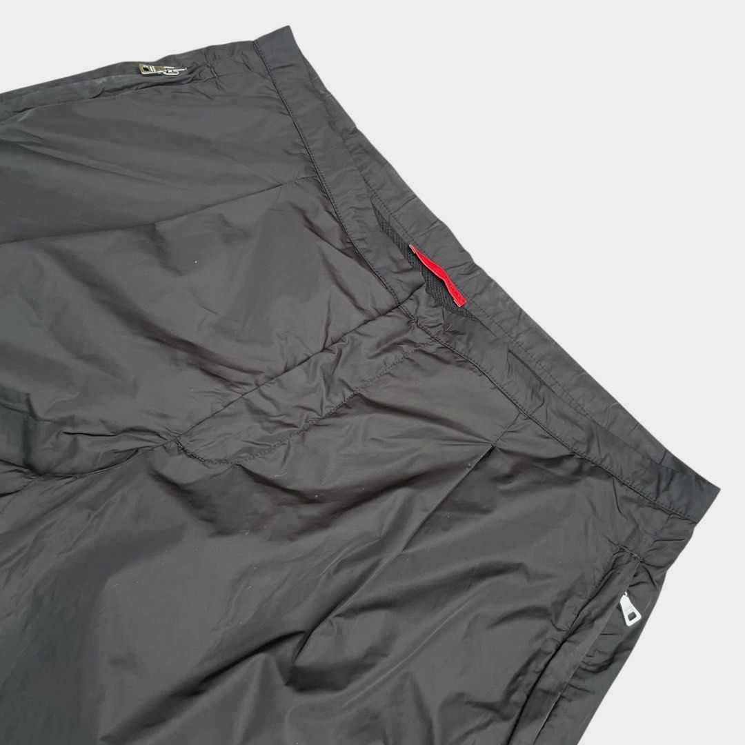 Prada - Vintage Red Tab Nylon Shorts (Category: Shorts) located in Los Banos. Submitted by declutterking (Listing ID 1460490579, Image 2). Description: Size 46 on tag • fits 32 waist • lace adjustment • snap button lock • mesh inner lining Dimensions: 16" waist 9.75" front rise 19" length 9.75" leg opening Excellent condition Authentic.