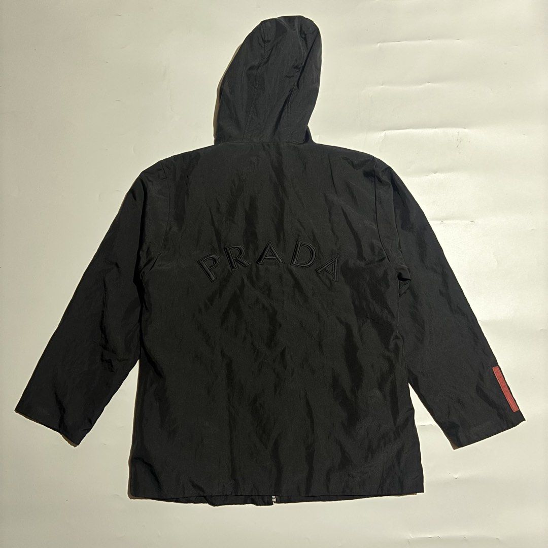 Prada Black Hooded Jacket Art. SGV126 (Category: Coats, Jackets and Outerwear) located in Cebu City. Submitted by kidfrom6000 (Listing ID 1460504318, Image 2). Description: - Authentic Prada hooded jacket - Made in Italy - 100% Polyester - Zip closure with pockets - Iconic Prada logo on the back - Red Prada tag on the sleeve - Ideal for everyday wear - Dimes are avail in the pics - cebu city - price + sf.