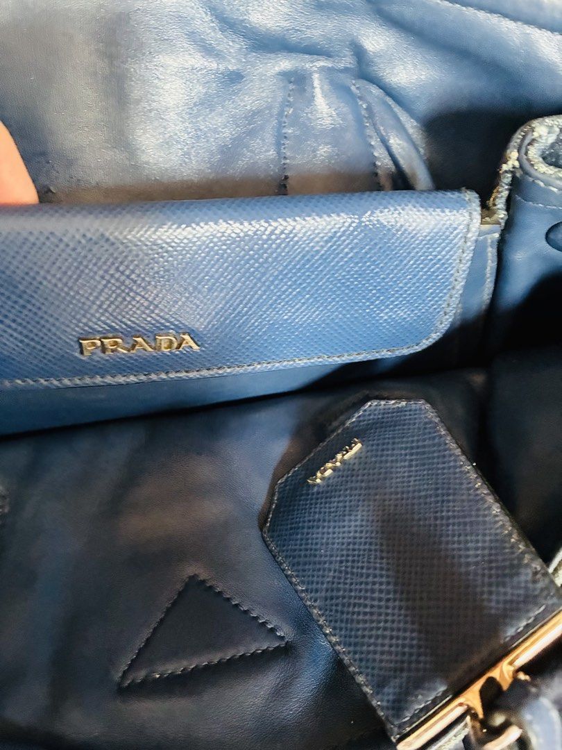 STEAL! Prada Denim Tote Bag (Category: Luxury Bags & Wallets) located in Angeles City. Submitted by meandshopping (Listing ID 1460314287, Image 3). Description: - Authentic Prada tote bag - Made from durable denim with blue leather accents - Comes with original dust bag - Interior features a zippered pocket and a separate pouch - Ideal for everyday use - Spacious enough for all your essentials - No major or noticeable flaws, just signs of use..