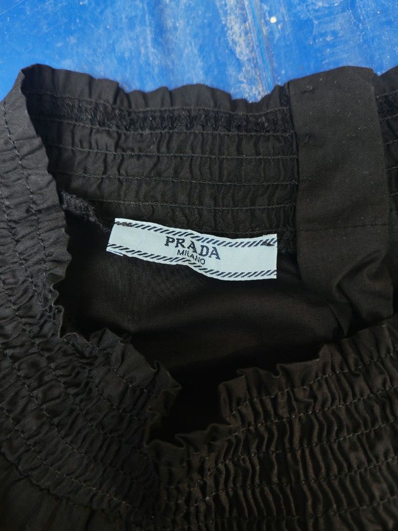 PRADA MILANO Black Smocked Neck Button Back Blouse Size 36 (Category: Blouses) located in Sipalay. Submitted by boldowl.e4f283 (Listing ID 1460403169, Image 3). Description: - Classic Prada blouse - Color: Black - Size: 36 - Features: Smocked neckline, long sleeves with button cuffs, full button-down back closure - Origin: Made in Vietnam.