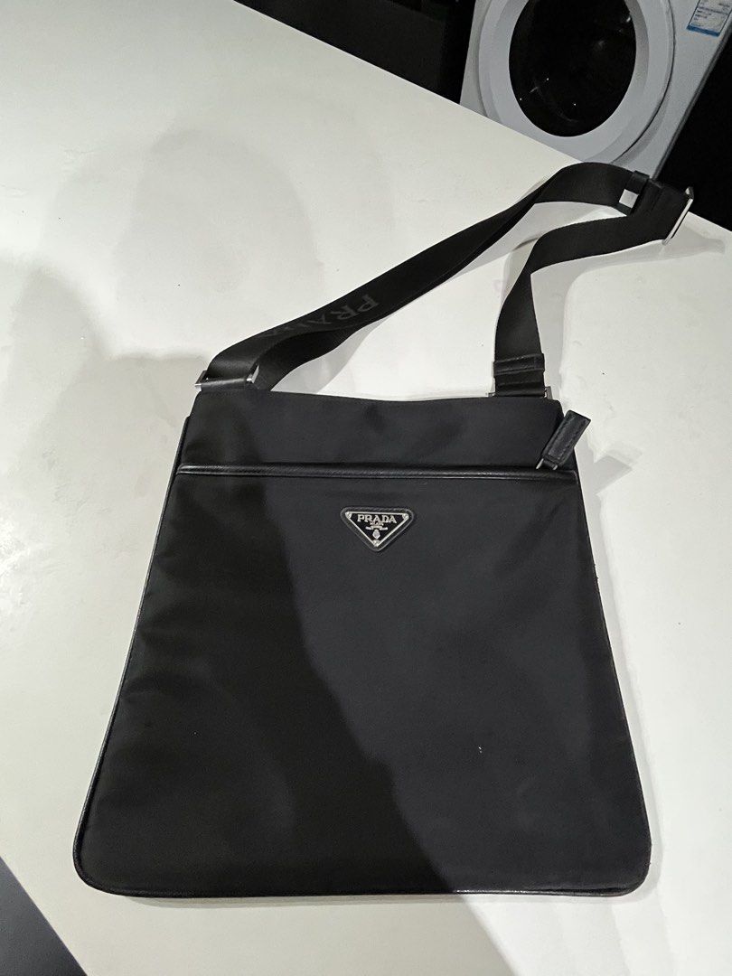 Prada Nylon Crossbody Bag Black (Category: Luxury Bags & Wallets) located in Makati City. Submitted by GoddessCloset (Listing ID 1460490206, Image 2). Description: - Material: Durable Nylon with Leather Trim - Adjustable Strap with Iconic Prada Logo - Secure Zippered Main Compartment - Convenient Front Pocket - Multiple Interior Compartments for Organization - Ideal for Everyday Use.