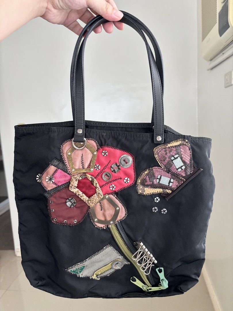 Prada Tessuto Flower Nylon Tote Bag (Category: Luxury Bags & Wallets) located in Manila. Submitted by notjaneahe05680 (Listing ID 1460461735, Image 3). Description: - Authentic Black Prada Nylon Tote Bag No issues, unli photo and check if you want. Used once or twice lang then nakastock nalang. Pm me your offer! Loc: Pangasinan.