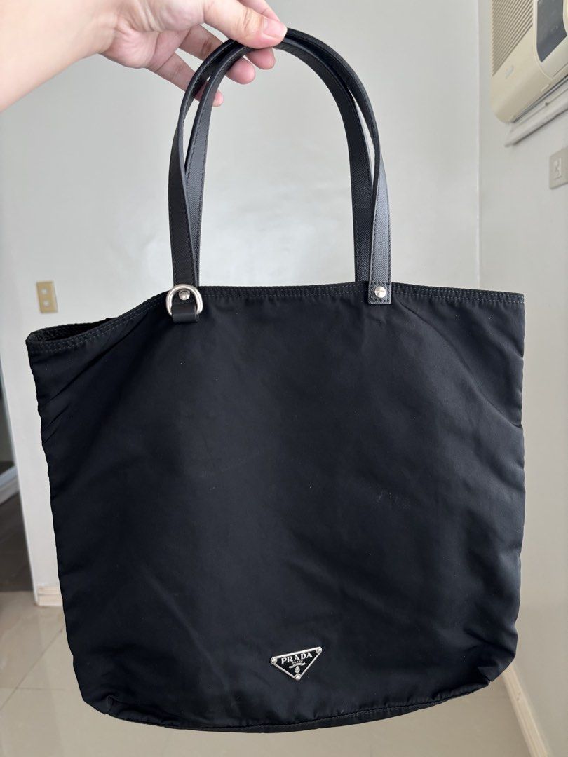 Prada Tessuto Flower Nylon Tote Bag (Category: Luxury Bags & Wallets) located in Manila. Submitted by notjaneahe05680 (Listing ID 1460461735, Image 2). Description: - Authentic Black Prada Nylon Tote Bag No issues, unli photo and check if you want. Used once or twice lang then nakastock nalang. Pm me your offer! Loc: Pangasinan.