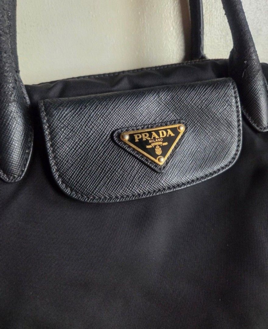 Prada Tessuto Saffian Nero convertible handbag (Category: Luxury Bags & Wallets) located in Quezon City. Submitted by stuffiesetc (Listing ID 1460426505, Image 3). Description: Prada BN2541 Tessuto Saffian Nero convertible handbag guaranteed authentic. bought in a prada store in italy for about Php58,000+. was used as an everyday bag but still in good condition. no holes,tear or stains. just minor signs of handling and use such as scuffs of the h