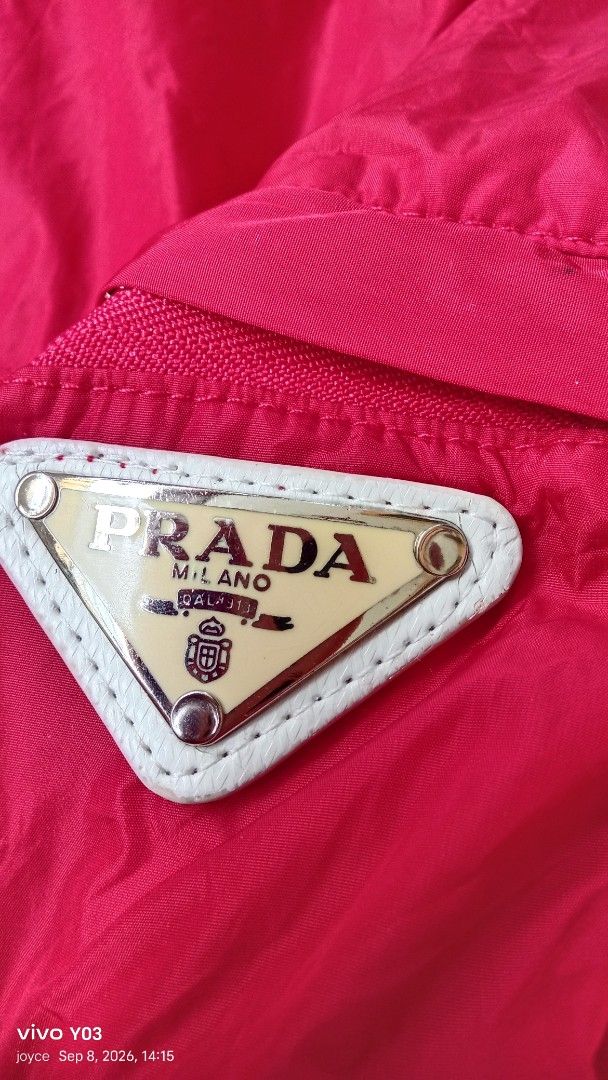 Preloved Prada Red Hooded Jacket (Category: Coats, Jackets and Outerwear) located in Cabuyao City. Submitted by selections888 (Listing ID 1460393975, Image 3). Description: - Red Prada jacket with hood - Zip closure - Iconic Prada triangle logo on sleeve - Adjustable cuffs - Ideal for windy days or light rain - Stylish and functional piece.