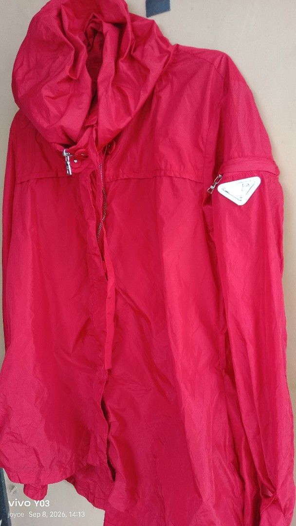 Preloved Prada Red Hooded Jacket (Category: Coats, Jackets and Outerwear) located in Cabuyao City. Submitted by selections888 (Listing ID 1460393975, Image 2). Description: - Red Prada jacket with hood - Zip closure - Iconic Prada triangle logo on sleeve - Adjustable cuffs - Ideal for windy days or light rain - Stylish and functional piece.