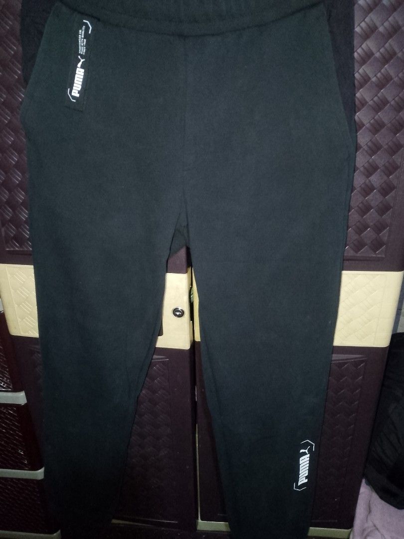 Puma Black Jogger Pants (Category: Joggers) located in Balaoan. Submitted by kulitzz (Listing ID 1460414188, Image 1). Description: - Black Puma jogger pants - Features Puma logo on left hip and down right leg - Made with quality since 1948 - Comfortable for everyday wear or workouts - Elastic waistband with drawstring - Two side pockets -Used Excellent Condition Personal Items Not Ukay PM if interested .