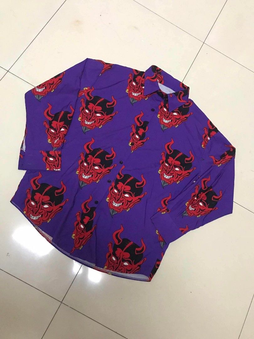 Purple Devil Face Print Long Sleeve Button Up Shirt (Category: Shirts) located in Manila. Submitted by youngstorm-c604 (Listing ID 1460427327, Image 2). Description: - Unique purple long-sleeve shirt - Features a repeating red devil face print - Button-up front - Loose and comfortable fit - Perfect for casual wear or making a statement.