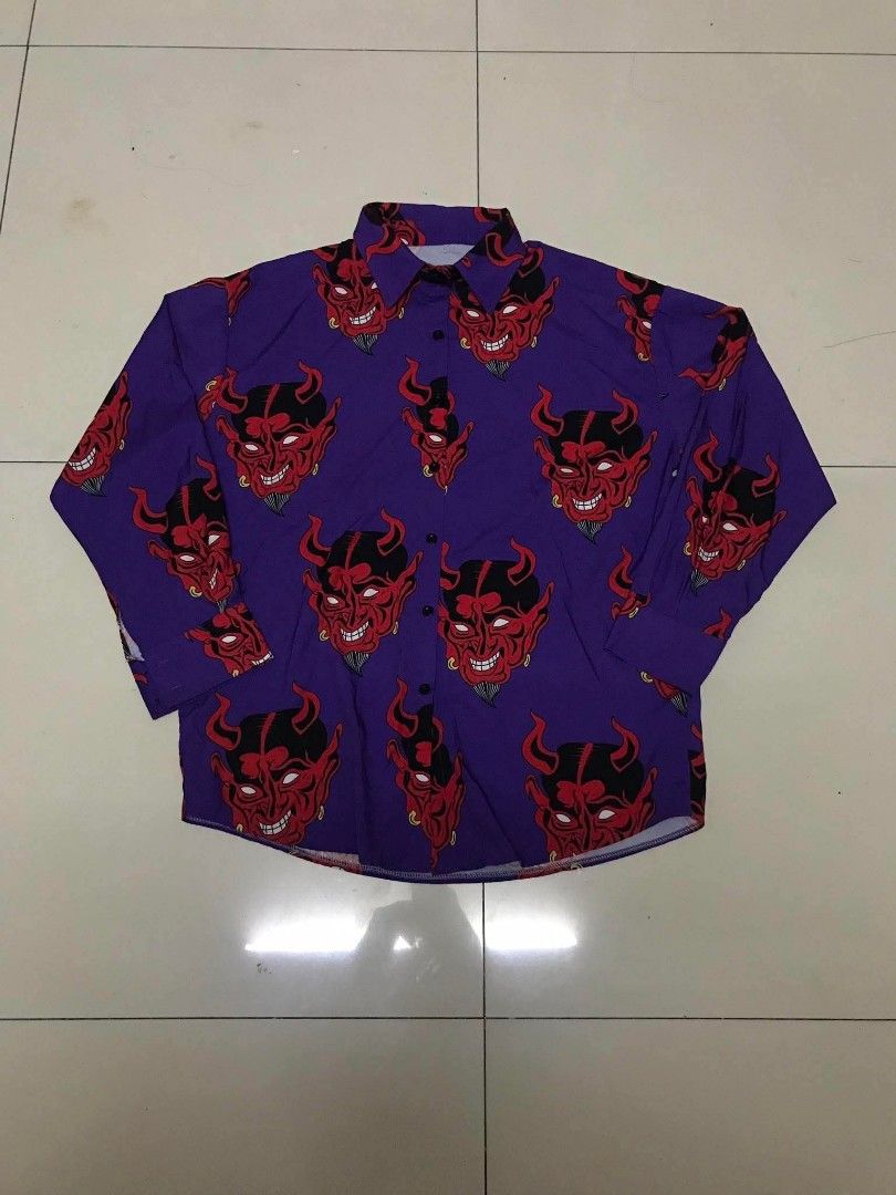 Purple Devil Face Print Long Sleeve Button Up Shirt (Category: Shirts) located in Manila. Submitted by youngstorm-c604 (Listing ID 1460427327, Image 1). Description: - Unique purple long-sleeve shirt - Features a repeating red devil face print - Button-up front - Loose and comfortable fit - Perfect for casual wear or making a statement.