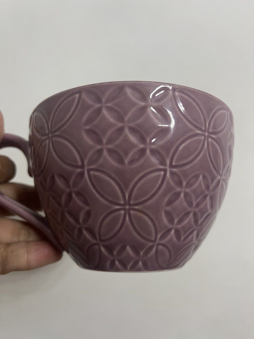 Purple Embossed Floral Mug (Category: Coffee & Tea Tableware) located in Dasmarinas. Submitted by purpleboxmidori (Listing ID 1460471776, Image 3). Description: - Charming purple mug - Embossed geometric pattern on the outside - Delicate floral design inside - Ideal size for morning coffee or tea - Comfortable, easy-to-hold handle - Perfect addition to your kitchenware collection.