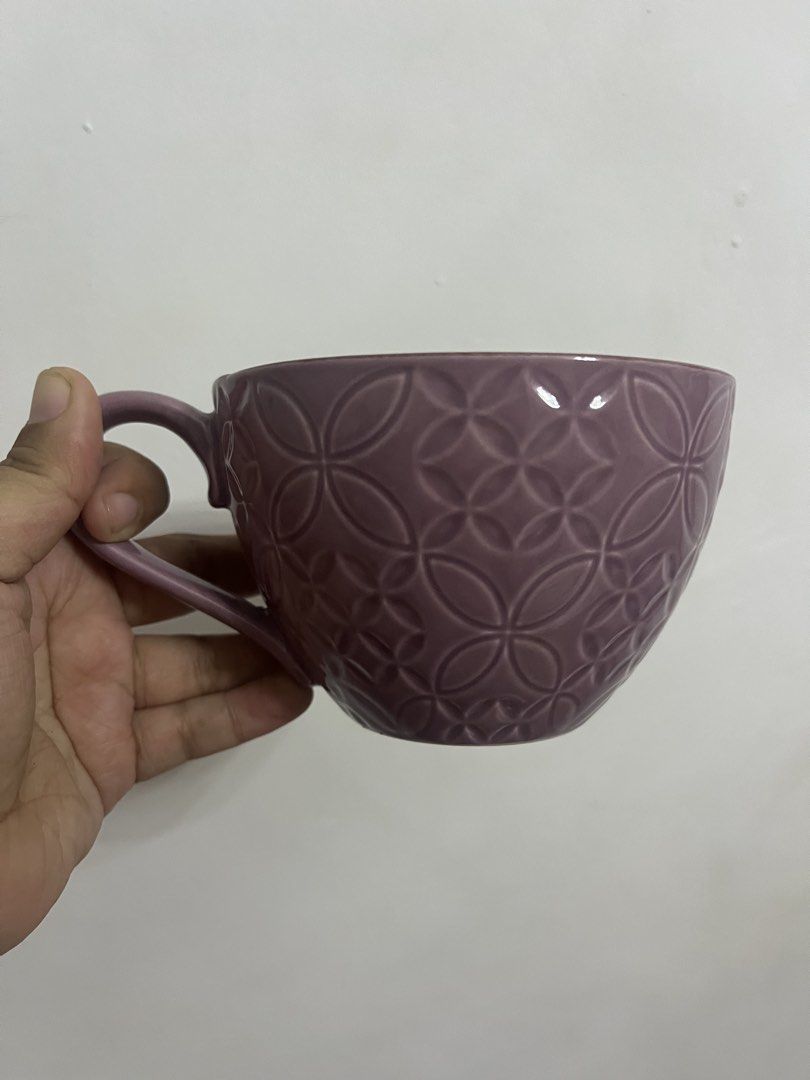 Purple Embossed Floral Mug (Category: Coffee & Tea Tableware) located in Dasmarinas. Submitted by purpleboxmidori (Listing ID 1460471776, Image 1). Description: - Charming purple mug - Embossed geometric pattern on the outside - Delicate floral design inside - Ideal size for morning coffee or tea - Comfortable, easy-to-hold handle - Perfect addition to your kitchenware collection.
