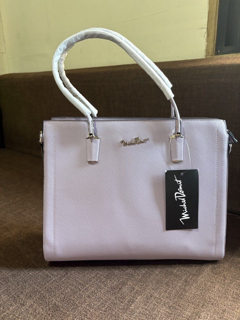 Purple totebag (Category: Tote Bags) located in Pototan. Submitted by tres_190725 (Listing ID 1460435775, Image 3). Description: The image shows a structured lavender faux-leather tote bag with top handles and a hanging brand tag..