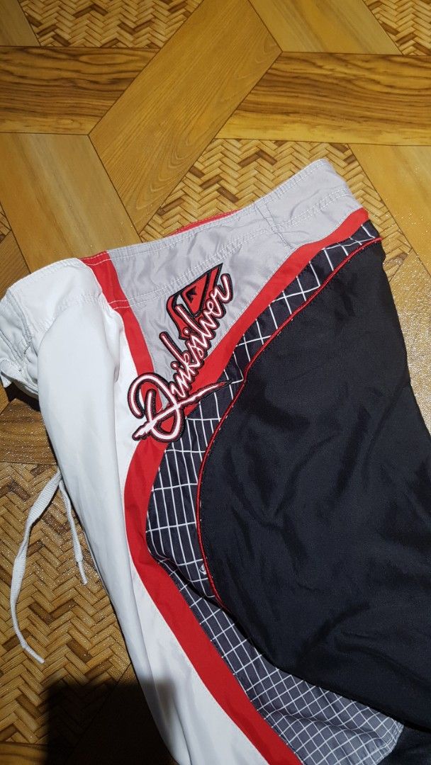 Quiksilver Board Shorts White Red Black Grid Pattern (Category: Swim Trunks & Board Shorts) located in Manila. Submitted by nice430 (Listing ID 1460319968, Image 2). Description: - Quiksilver board shorts - White with red and black grid accents on the sides - Drawstring waist for adjustable fit - Perfect for swimming, surfing, or lounging - In good, pre-loved condition.