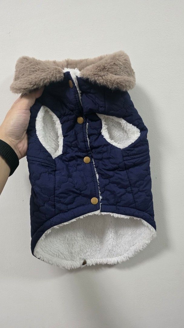 Quilted Dog Coat with Fur Trim (Category: Coats, Jackets and Outerwear) located in Muntinlupa City. Submitted by dogsmakemehappy (Listing ID 1460469974, Image 1). Description: - Navy blue quilted dog coat - Soft, fluffy white lining for warmth - Faux fur trim around neck and chest - Easy snap button closure - Built-in D-ring for leash attachment - "Dadagou" embroidery on the back - Keeps your furry friend cozy and stylish.