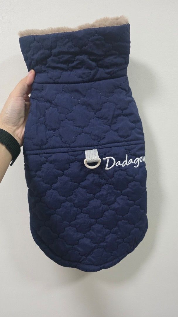 Quilted Dog Coat with Fur Trim (Category: Coats, Jackets and Outerwear) located in Muntinlupa City. Submitted by dogsmakemehappy (Listing ID 1460469974, Image 2). Description: - Navy blue quilted dog coat - Soft, fluffy white lining for warmth - Faux fur trim around neck and chest - Easy snap button closure - Built-in D-ring for leash attachment - "Dadagou" embroidery on the back - Keeps your furry friend cozy and stylish.