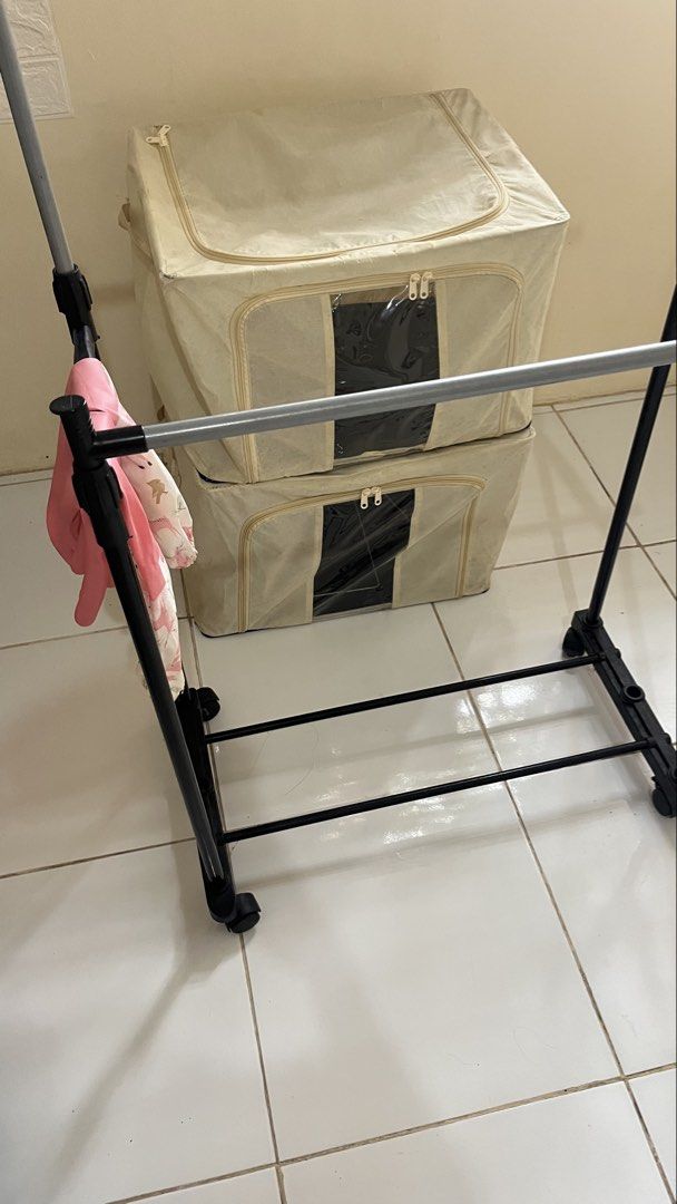 racks, 2storage box (Category: Hooks & Hangers) located in Manila. Submitted by jana0011 (Listing ID 1460308239, Image 3). Description: - Portable drying rack with two rails for hanging clothes. - Folds flat for convenient storage. - Equipped with wheels for easy mobility. - Ideal for small spaces, apartments, indoors, or outdoors. - Simple and quick assembly..