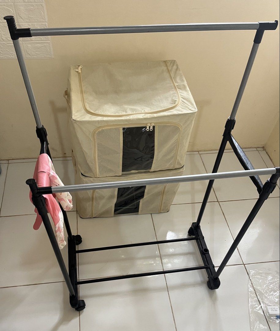racks, 2storage box (Category: Hooks & Hangers) located in Manila. Submitted by jana0011 (Listing ID 1460308239, Image 2). Description: - Portable drying rack with two rails for hanging clothes. - Folds flat for convenient storage. - Equipped with wheels for easy mobility. - Ideal for small spaces, apartments, indoors, or outdoors. - Simple and quick assembly..