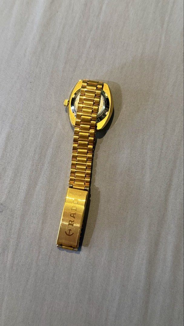 Rado Quartz Watch Gold Tone (Category: Women's Watches) located in Pasig City. Submitted by macath02508 (Listing ID 1460322550, Image 3). Description: - Authentic Rado gold tone watch - Quartz movement - Diamond markers on face - Scratchproof and water resistant - Model number: 129.0033.3 - Adjustable bracelet - Clasp features Rado logo.