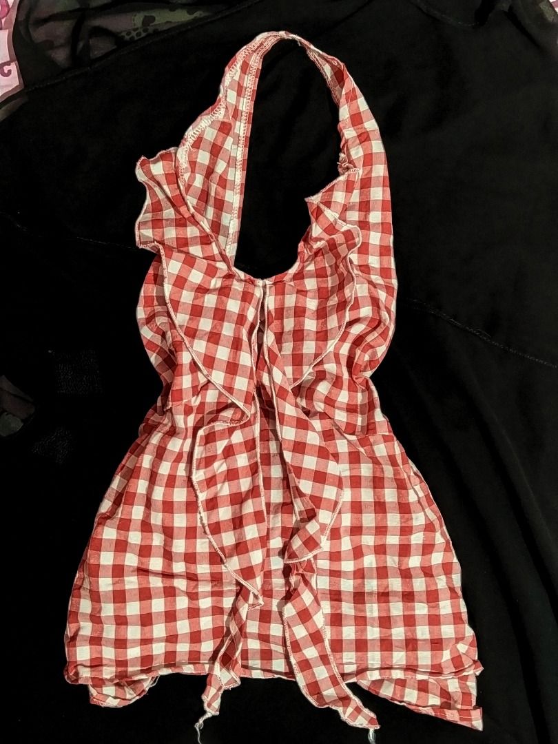 Red Gingham Halter Neck Ruffle Top with Tie Back (Category: Sleeveless) located in Caloocan City. Submitted by xoxo_eyuh (Listing ID 1460456063, Image 2). Description: Large on tag, can fit Medium. - Adorable red and white gingham halter top - Features a ruffled neckline - Secure tie-back closure with a cute bow detail - Versatile styling: pairs well with jeans or shorts - Ideal for summer outings and casual wear - Flattering fit.