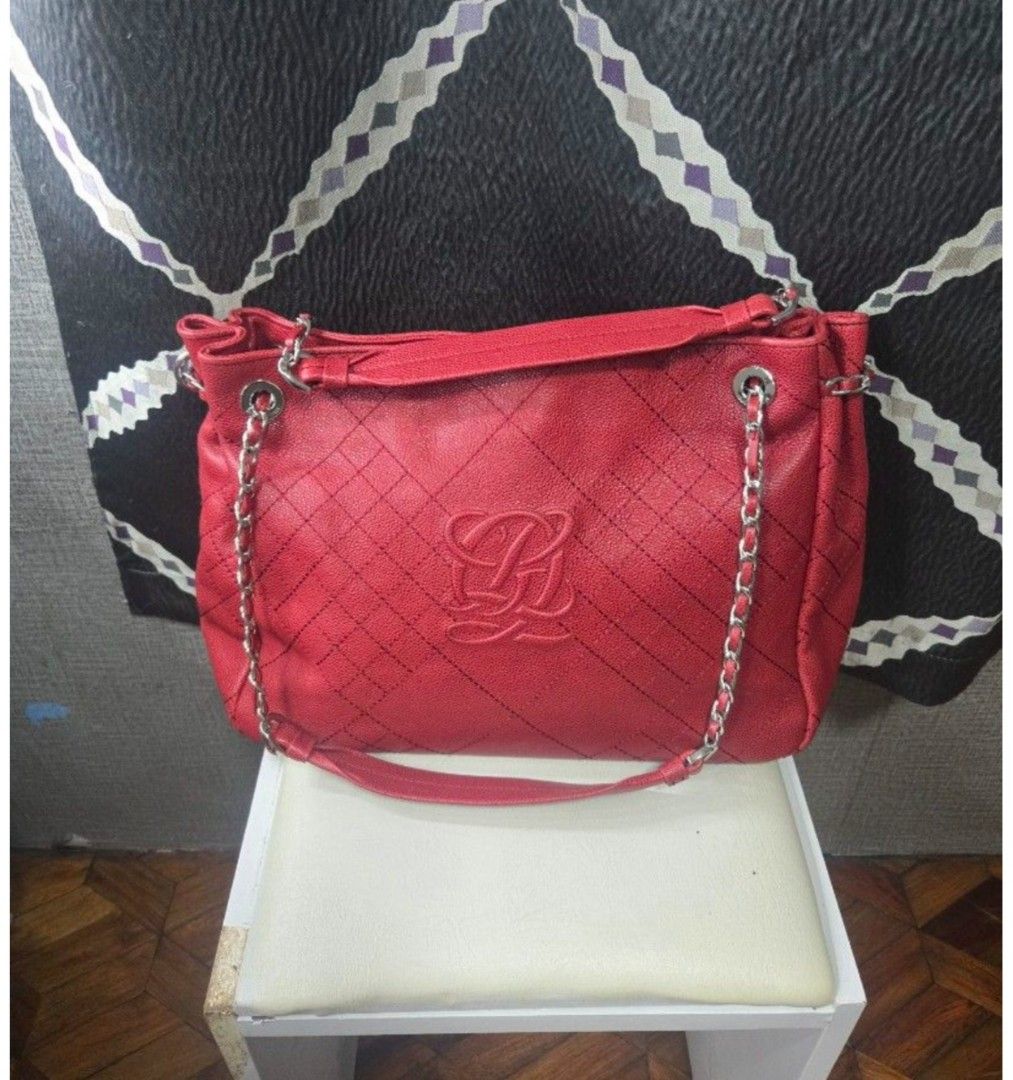 Red Quatorze Leather Quilted Shoulder Bag (Category: Other Accessories) located in Quezon City. Submitted by affordabags_cd (Listing ID 1460425082, Image 1). Description: - Genuine red leather shoulder bag - Elegant quilted pattern - Prominent 'LQ' logo on the front - Stylish silver chain detailing on straps - Interior with branded tag and patterned lining - Protective studs on the bottom - Spacious for daily essentials.