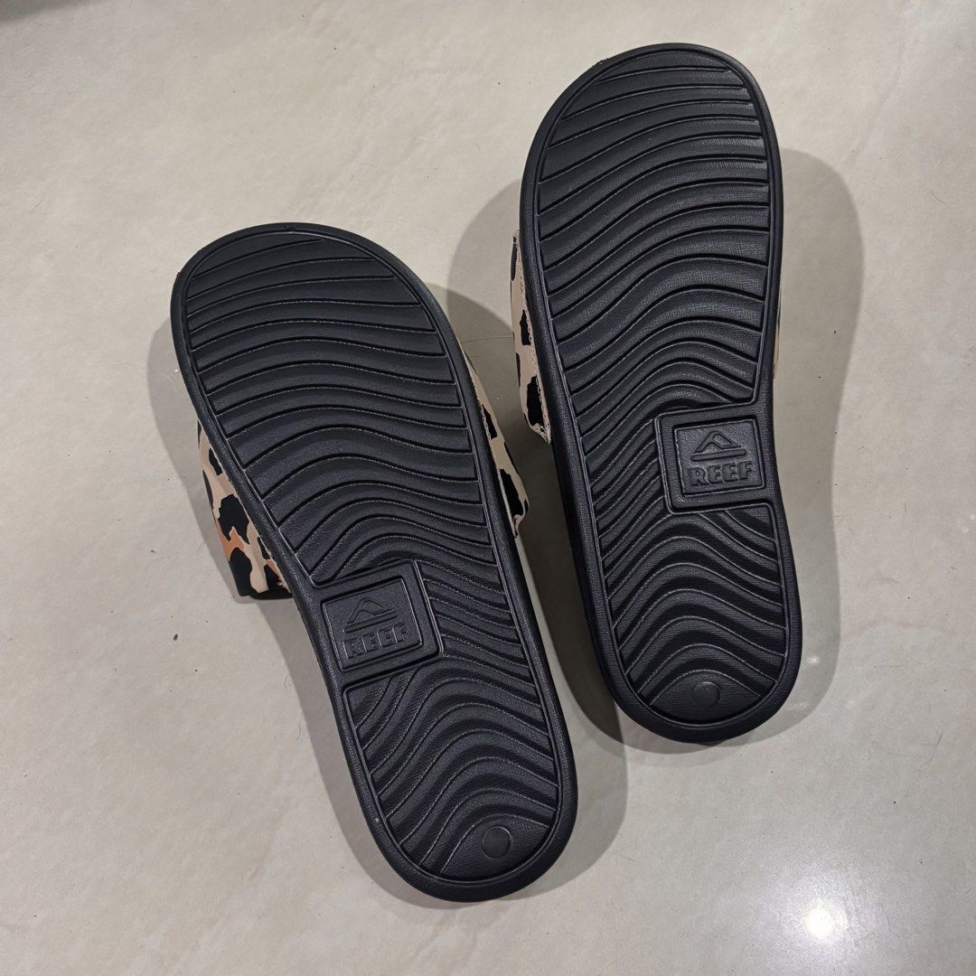 Reef Leopard Print Slides Sandals (Category: Slippers and slides) located in Manila. Submitted by jc_bodega (Listing ID 1460335831, Image 3). Description: Negotiable! Message me 🛍️ - Leopard print black Reef slides - Wavy sole pattern + padding - Good for outdoor activities, beach, swims, etc. - Authentic Reef branding visible on sole and strap - Wear: Never been worn, no tag.