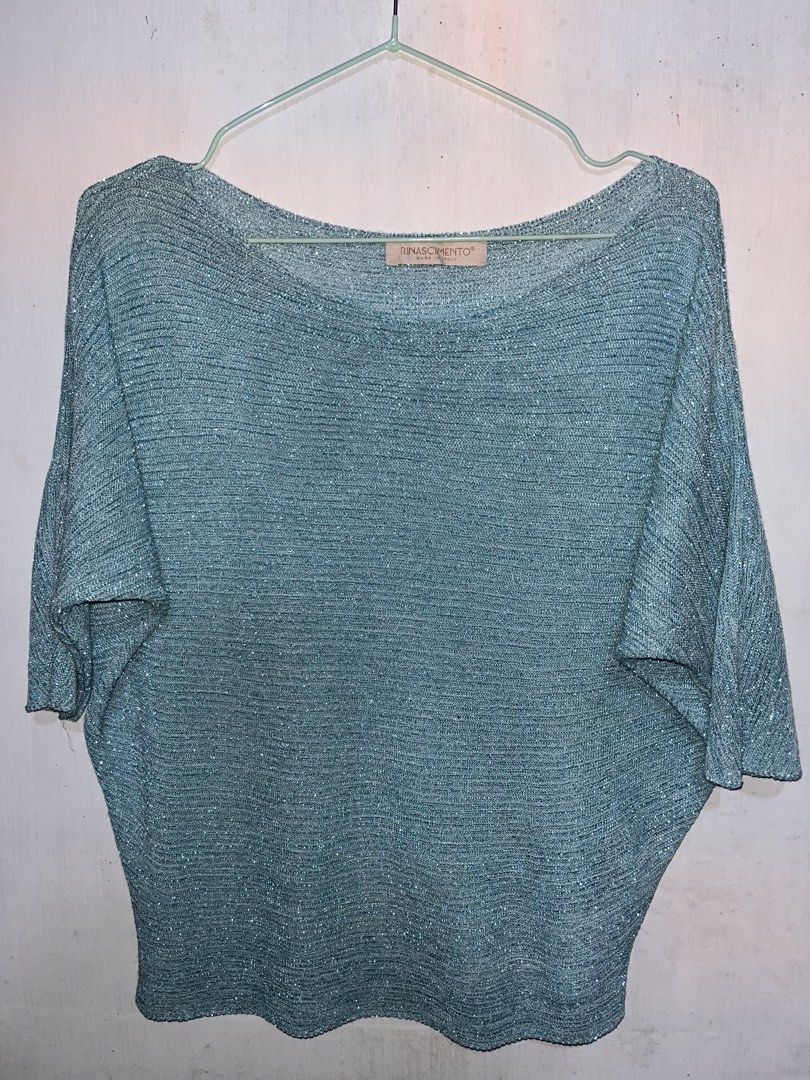 RINASCIMENTO Teal Glitter Batwing Knit Top (Category: Others Tops) located in Mexico. Submitted by amaya_thriftstore (Listing ID 1460445915, Image 1). Description: Color: Teal / Dusty Blue with shimmer Style: Oversized batwing sleeves, wide boat neck, ribbed knit Fabric: Lightweight knit with glitter lurex thread - may sparkle siya Vibes: Italian luxury, Glam casual, Evening / Party Best paired with: Highwaist pants, skirt, or leggings.