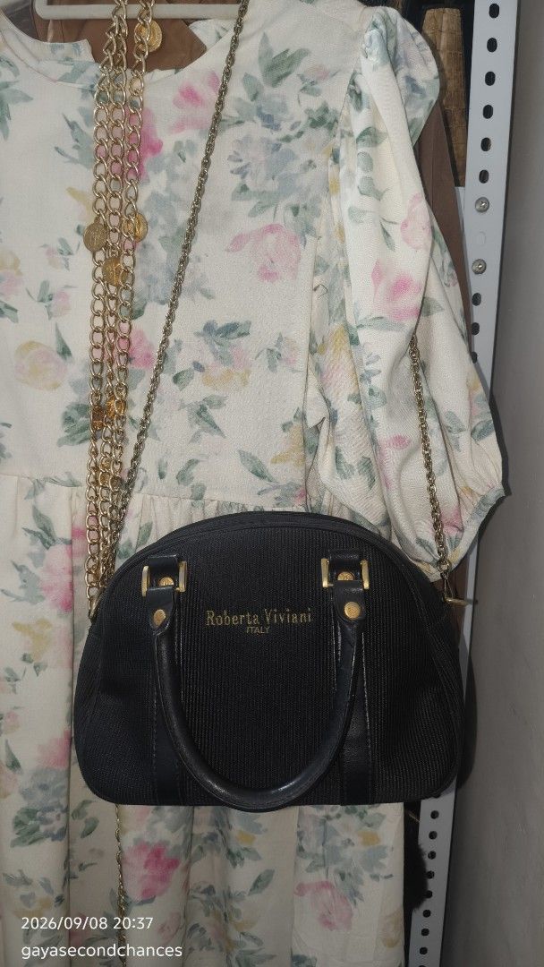 ROBERTA VIVIANI ITALY SHOULDER BAG (Category: Cross-body Bags) located in Kalibo. Submitted by secondchances.thriftsh8p (Listing ID 1460450253, Image 2). Description: - Authentic Roberta Viviani handbag from Italy - Elegant dome shape - Textured material with luxurious leather trim - Chic gold hardware details - Includes a detachable gold chain strap for versatile styling - Clean and well-maintained interior - Ideal for both daytime and evening o