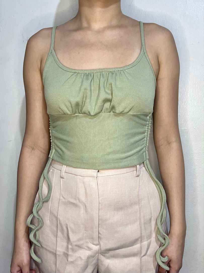 Sage Green Ruched Cami Top (Category: Blouses) located in Marikina City. Submitted by trish.grcia (Listing ID 1460379758, Image 1). Description: • Ribbed & ruched detail • Adjustable side ties • Stretchy fit • Preloved, good condition .