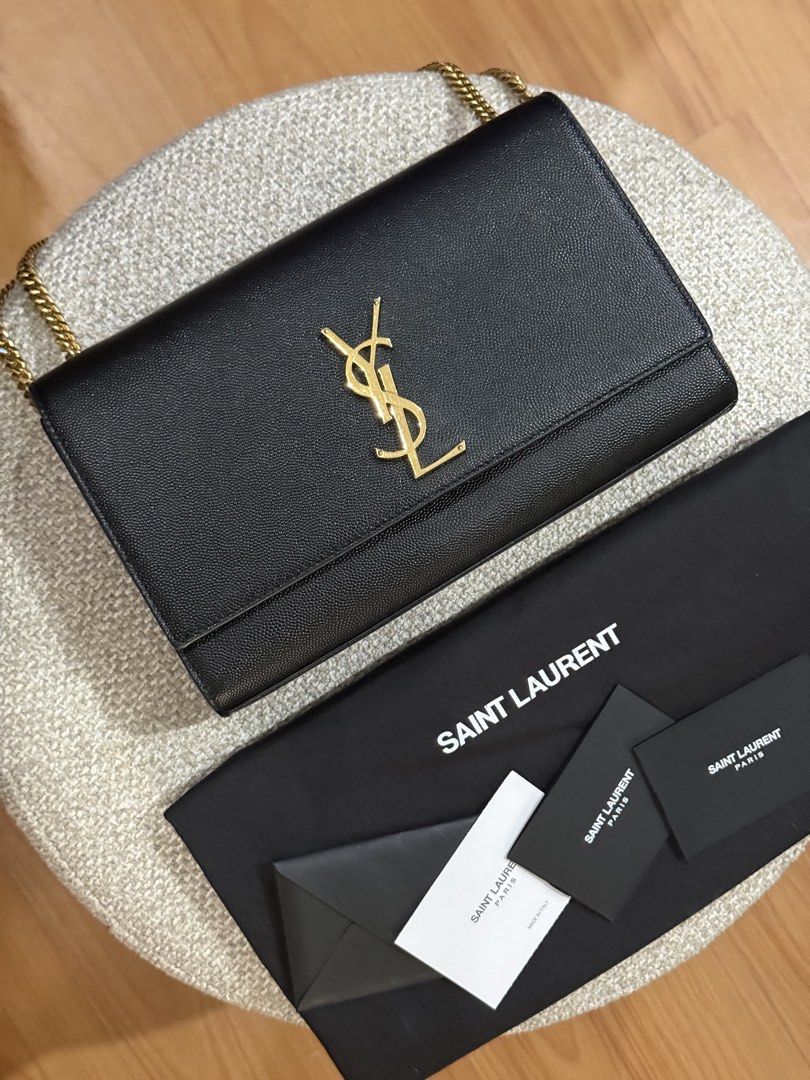 YSL Kate in medium (Category: Luxury Bags & Wallets) located in Quezon City. Submitted by happy_findds (Listing ID 1460438763, Image 1). Description: - Authentic pre loved Saint Laurent Kate in medium - Material: Black pebbled leather - Hardware: Gold-tone YSL logo - Condition: Great exterior, clean interior - Includes: Dust bag and authenticity cards - Strap: can wear crossbody or on shoulder o can be use as handbag.